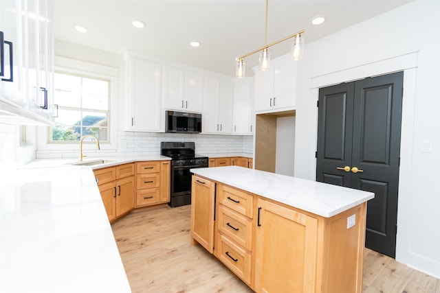 2284 Sistine Chapel Cir, Jonesboro, AR 72404 - kitchen with black range oven, stainless steel microwave, backsplash, light wood-style flooring, and a center island