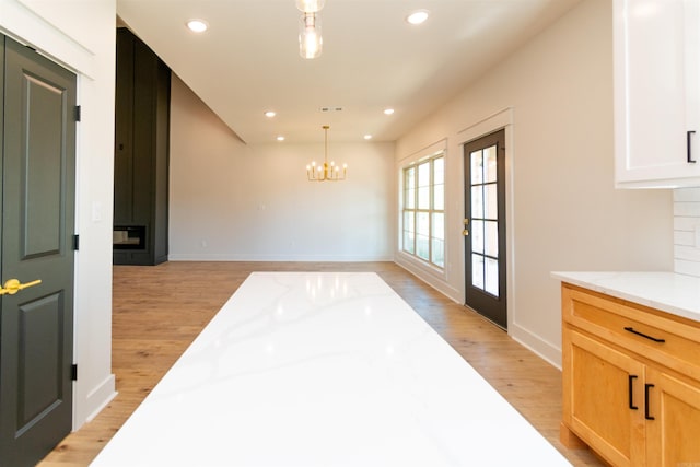 2284 Sistine Chapel Cir, Jonesboro, AR 72404 - unfurnished dining area with light wood-type flooring, a chandelier, a fireplace, and recessed lighting
