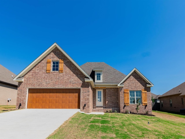 2284 Sistine Chapel Cir, Jonesboro, AR 72404 - view of front facade featuring concrete driveway, brick siding, a front yard, and an attached garage