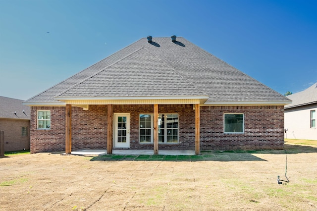 2284 Sistine Chapel Cir, Jonesboro, AR 72404 - rear view of property featuring a shingled roof, brick siding, and a patio area