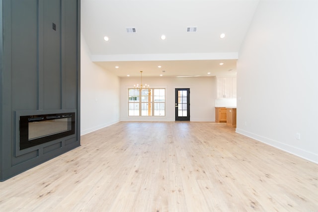 2284 Sistine Chapel Cir, Jonesboro, AR 72404 - unfurnished living room with a chandelier, light wood-style floors, a large fireplace, and recessed lighting