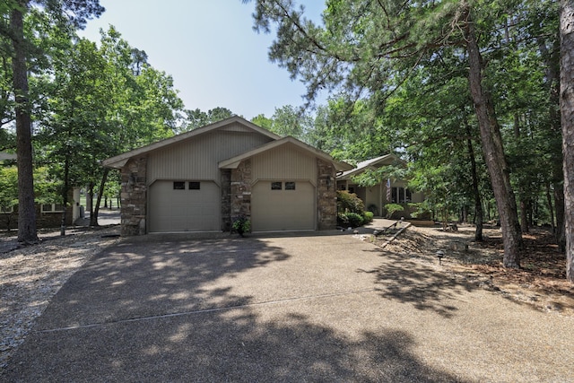 96 San Sebastian Way, Hot Springs Village, AR 71909 - view of home's exterior featuring a garage, concrete driveway, and stone siding