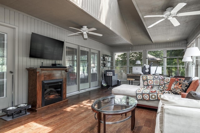 96 San Sebastian Way, Hot Springs Village, AR 71909 - living room featuring ceiling fan, hardwood / wood-style floors, a glass covered fireplace, and wooden walls