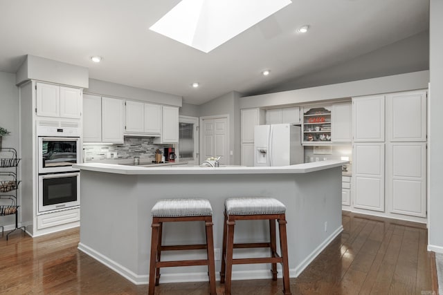 96 San Sebastian Way, Hot Springs Village, AR 71909 - kitchen featuring white appliances, white cabinetry, dark wood-type flooring, light countertops, and lofted ceiling