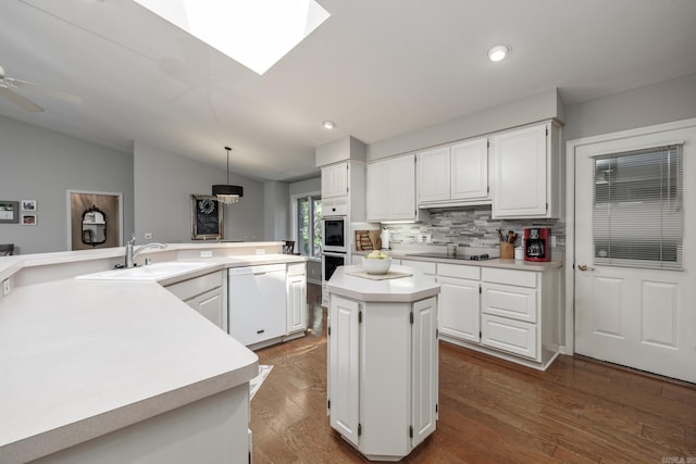 96 San Sebastian Way, Hot Springs Village, AR 71909 - kitchen featuring white appliances, light countertops, a center island, backsplash, and white cabinetry