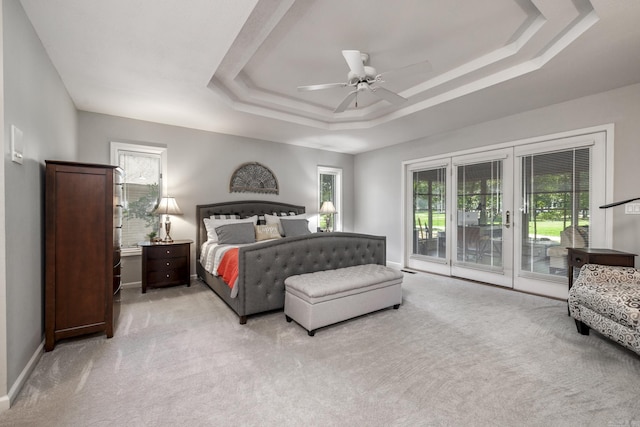 96 San Sebastian Way, Hot Springs Village, AR 71909 - bedroom featuring a tray ceiling, access to outside, light colored carpet, and a ceiling fan