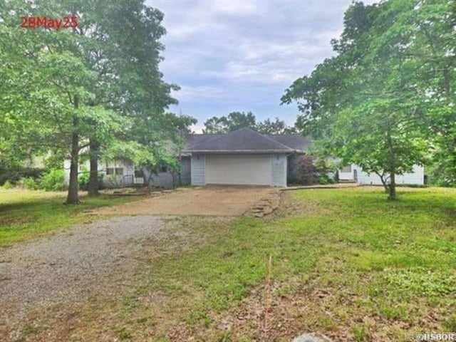 1116 Mccracken Ridge Rd, Mountain Home, AR 72653 - view of front of home with concrete driveway, an attached garage, and a front yard