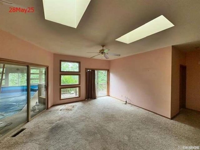 1116 Mccracken Ridge Rd, Mountain Home, AR 72653 - carpeted empty room featuring a skylight and a ceiling fan