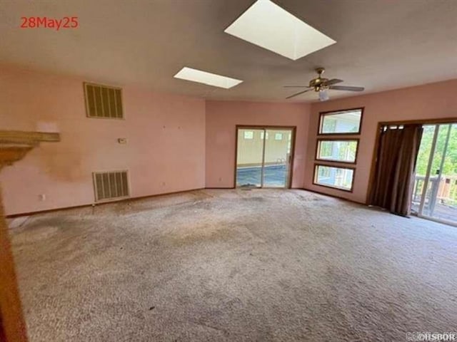 1116 Mccracken Ridge Rd, Mountain Home, AR 72653 - unfurnished living room featuring a skylight, carpet floors, and ceiling fan