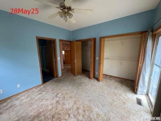1116 Mccracken Ridge Rd, Mountain Home, AR 72653 - unfurnished bedroom featuring two closets, carpet flooring, and ceiling fan