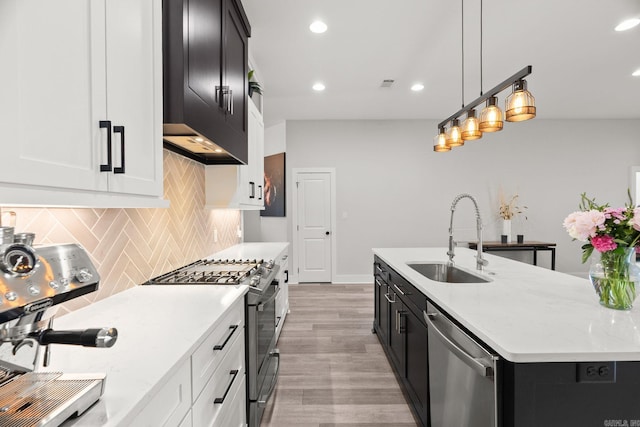 127 Copper Cir, Little Rock, AR 72223 - kitchen with appliances with stainless steel finishes, dark cabinets, tasteful backsplash, recessed lighting, and light wood finished floors