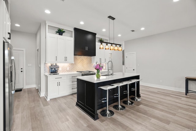 127 Copper Cir, Little Rock, AR 72223 - kitchen with appliances with stainless steel finishes, light countertops, tasteful backsplash, light wood-type flooring, and recessed lighting