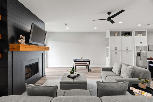 127 Copper Cir, Little Rock, AR 72223 - living room featuring ceiling fan, a large fireplace, light wood-style floors, and recessed lighting