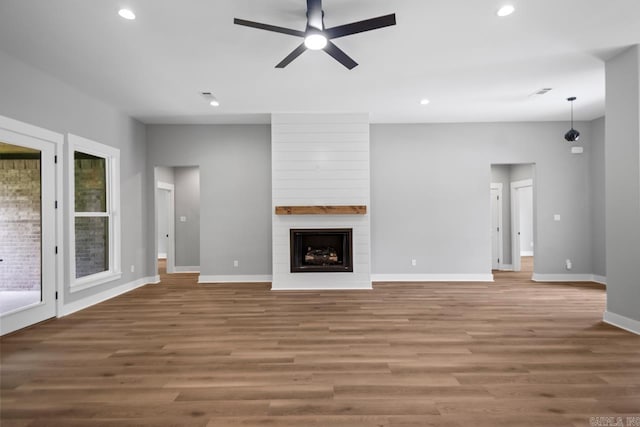 6185 Creekwater, Bryant, AR 72002 - unfurnished living room with a ceiling fan, recessed lighting, wood finished floors, and a fireplace