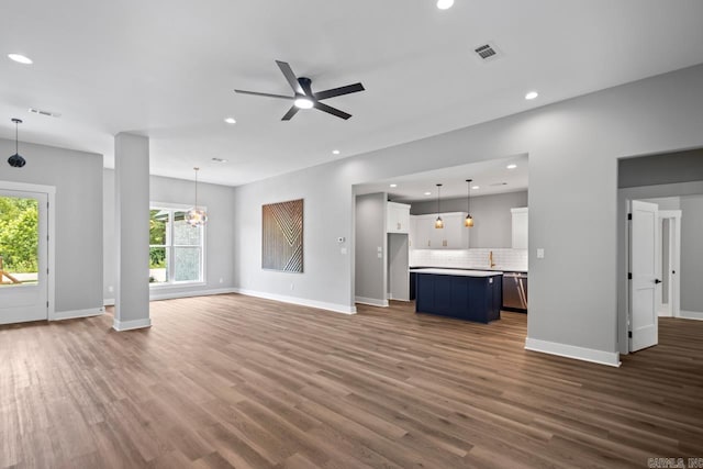 6185 Creekwater, Bryant, AR 72002 - unfurnished living room featuring dark wood finished floors, ceiling fan, recessed lighting, and a chandelier