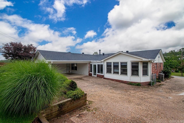 11414 E Stoney Point Ct, Little Rock, AR 72211 - rear view of house featuring concrete driveway, an attached carport, and brick siding