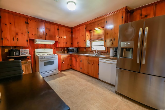 3215 Edgewood Rd, El Dorado, AR 71730 - kitchen featuring appliances with stainless steel finishes, under cabinet range hood, brown cabinetry, and light flooring
