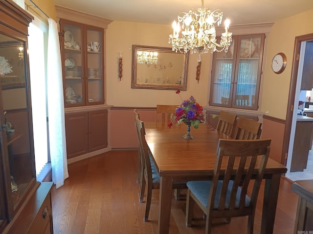1402 Holmes Rd, Searcy, AR 72143 - dining area with wood finished floors, a chandelier, and plenty of natural light