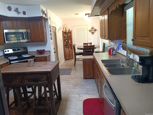 1402 Holmes Rd, Searcy, AR 72143 - kitchen featuring appliances with stainless steel finishes, stone tile flooring, and light countertops