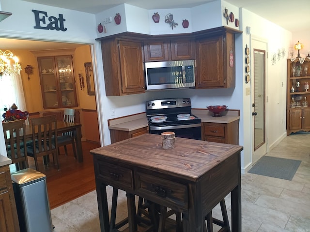 1402 Holmes Rd, Searcy, AR 72143 - kitchen featuring stainless steel appliances, a chandelier, and light countertops