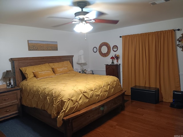 1402 Holmes Rd, Searcy, AR 72143 - bedroom with dark wood-type flooring and ceiling fan