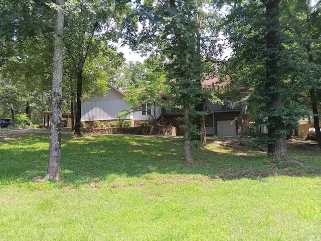 1402 Holmes Rd, Searcy, AR 72143 - view of green lawn featuring a garage