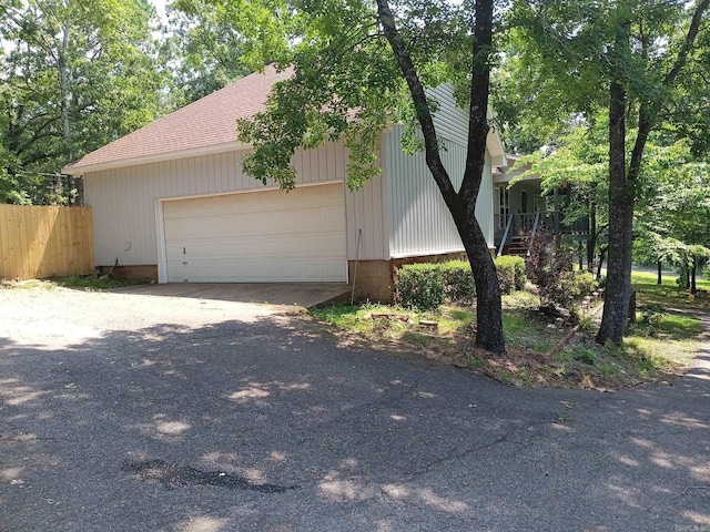 1402 Holmes Rd, Searcy, AR 72143 - view of front of home with a garage and a shingled roof