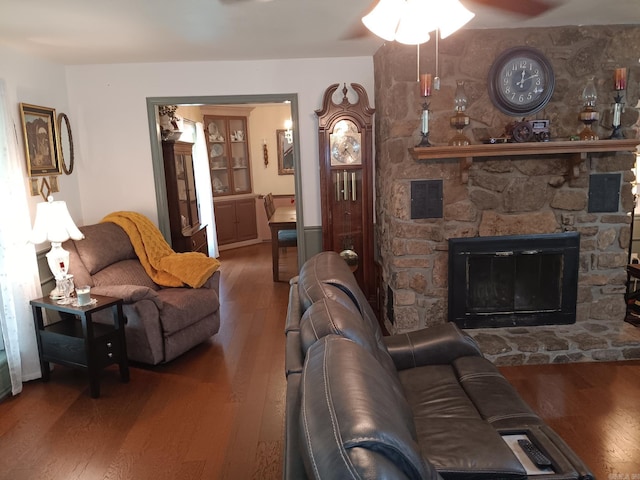 1402 Holmes Rd, Searcy, AR 72143 - living room featuring wood-type flooring, a ceiling fan, and a stone fireplace