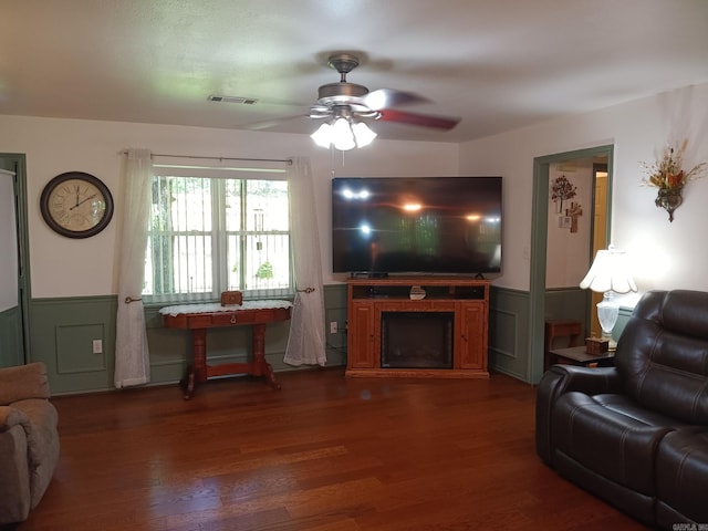 1402 Holmes Rd, Searcy, AR 72143 - living room featuring wainscoting, ceiling fan, dark wood-style flooring, and a decorative wall