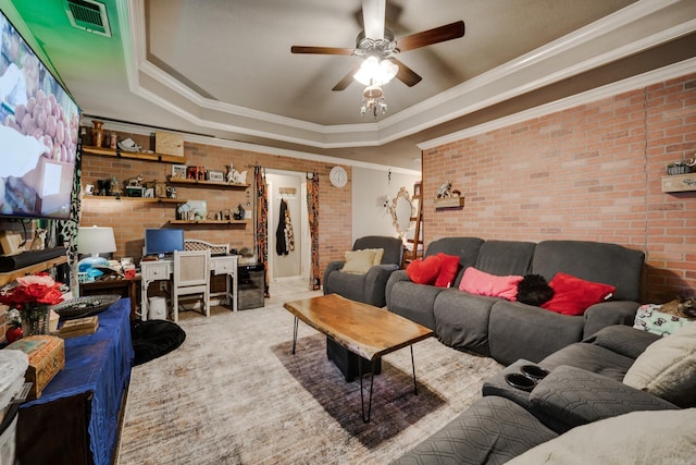 344 Austin Creek Dr, Austin, AR 72007 - living room with a tray ceiling, brick wall, a ceiling fan, ornamental molding, and carpet flooring