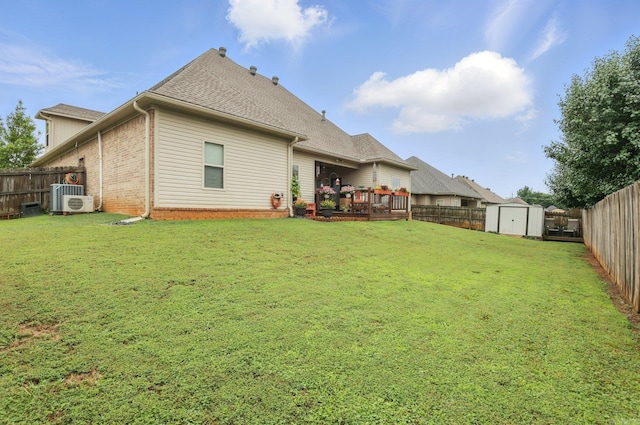 3051 Mount Mcgregor Dr, Benton, AR 72019 - back of property featuring a shed, a fenced backyard, brick siding, a wooden deck, and a shingled roof