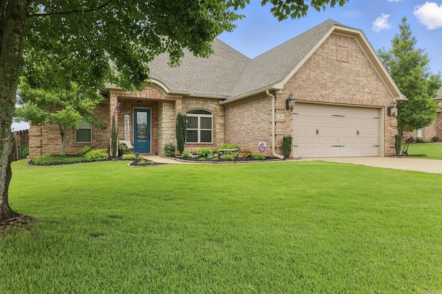 3051 Mount Mcgregor Dr, Benton, AR 72019 - view of front of home featuring roof with shingles, a garage, a front yard, and concrete driveway