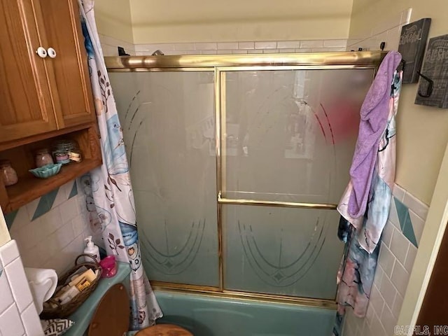 123 Quilters Ln, Hot Springs, AR 71909 - bathroom with tile walls and combined bath / shower with glass door