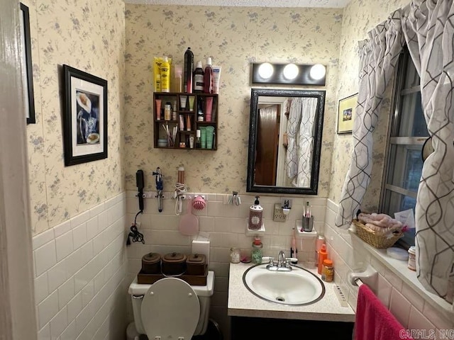 123 Quilters Ln, Hot Springs, AR 71909 - bathroom featuring wallpapered walls, a wainscoted wall, vanity, and tile walls