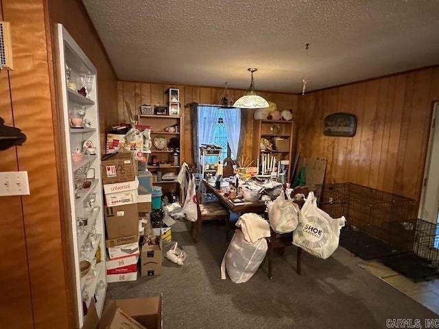 123 Quilters Ln, Hot Springs, AR 71909 - dining room featuring wood walls, a textured ceiling, and carpet floors