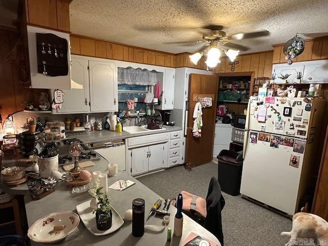 123 Quilters Ln, Hot Springs, AR 71909 - kitchen with white appliances, a ceiling fan, wooden walls, white cabinets, and carpet flooring