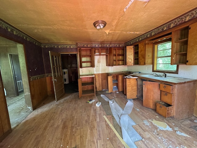 104 Crumpler, Altus, AR 72821 - kitchen with open shelves, water heater, brown cabinets, and wood-type flooring