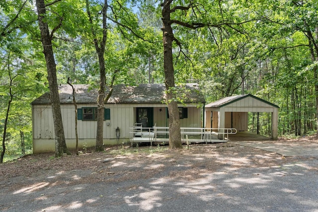 101 Winchester Ct, Fairfield Bay, AR 72088 - view of front of house with a carport, driveway, and board and batten siding