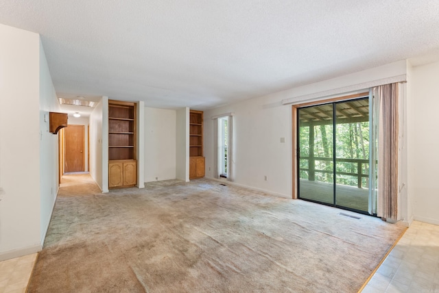 101 Winchester Ct, Fairfield Bay, AR 72088 - unfurnished living room with a textured ceiling, built in shelves, and light colored carpet