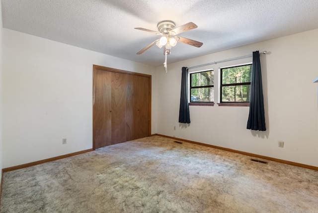 101 Winchester Ct, Fairfield Bay, AR 72088 - unfurnished bedroom featuring carpet, a closet, a textured ceiling, and a ceiling fan