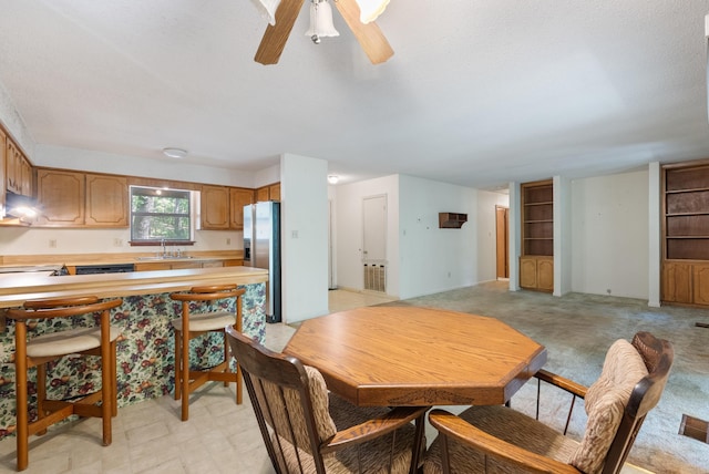 101 Winchester Ct, Fairfield Bay, AR 72088 - dining space featuring ceiling fan, a textured ceiling, and light colored carpet