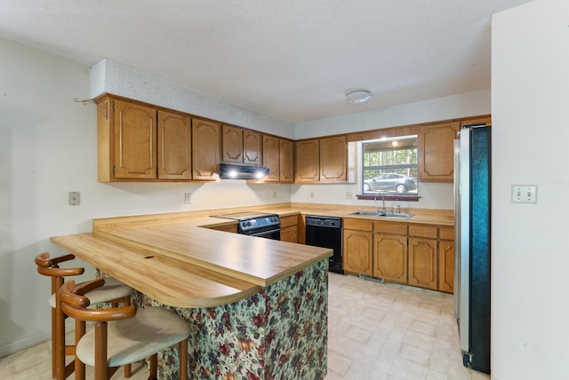 101 Winchester Ct, Fairfield Bay, AR 72088 - kitchen with black dishwasher, freestanding refrigerator, range with electric stovetop, a peninsula, and exhaust hood