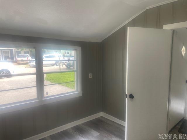 741 Macarthur Ave, Wake Village, TX 75501 - empty room featuring vaulted ceiling and dark wood-style flooring