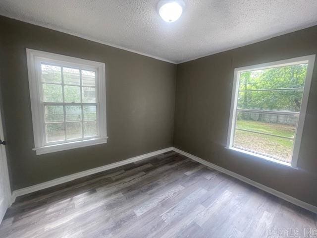 741 Macarthur Ave, Wake Village, TX 75501 - unfurnished room with a textured ceiling, wood finished floors, and healthy amount of natural light