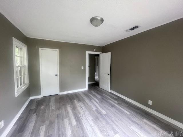 741 Macarthur Ave, Wake Village, TX 75501 - unfurnished bedroom featuring dark wood-style floors
