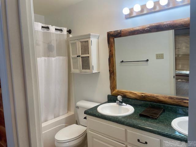 full bathroom featuring double vanity and shower / bath combo with shower curtain
