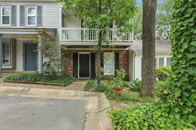 49 Kingsbridge Way, Little Rock, AR 72212 - view of front facade featuring a balcony, brick siding, and a porch