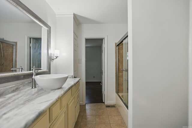 49 Kingsbridge Way, Little Rock, AR 72212 - full bathroom with vanity, tile patterned flooring, and combined bath / shower with glass door