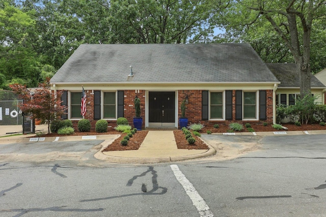 49 Kingsbridge Way, Little Rock, AR 72212 - view of front of home with uncovered parking, brick siding, and a shingled roof