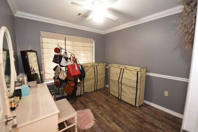 misc room featuring a ceiling fan, crown molding, and dark wood finished floors